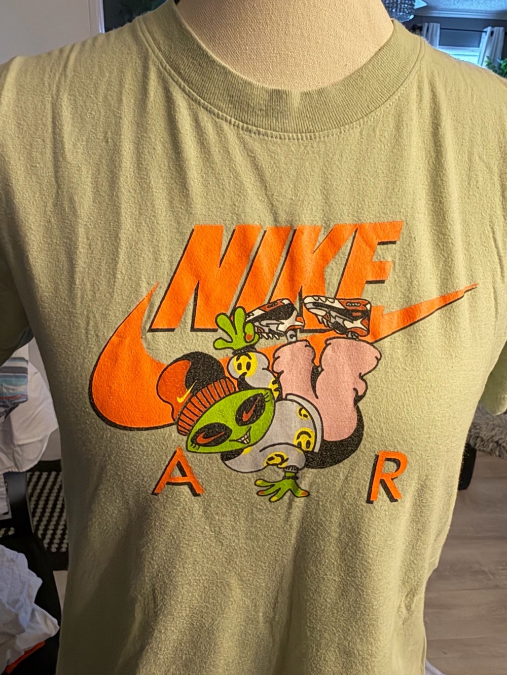 Nike Olive Green Tee with Bright Orange Logo and Playful Graphic